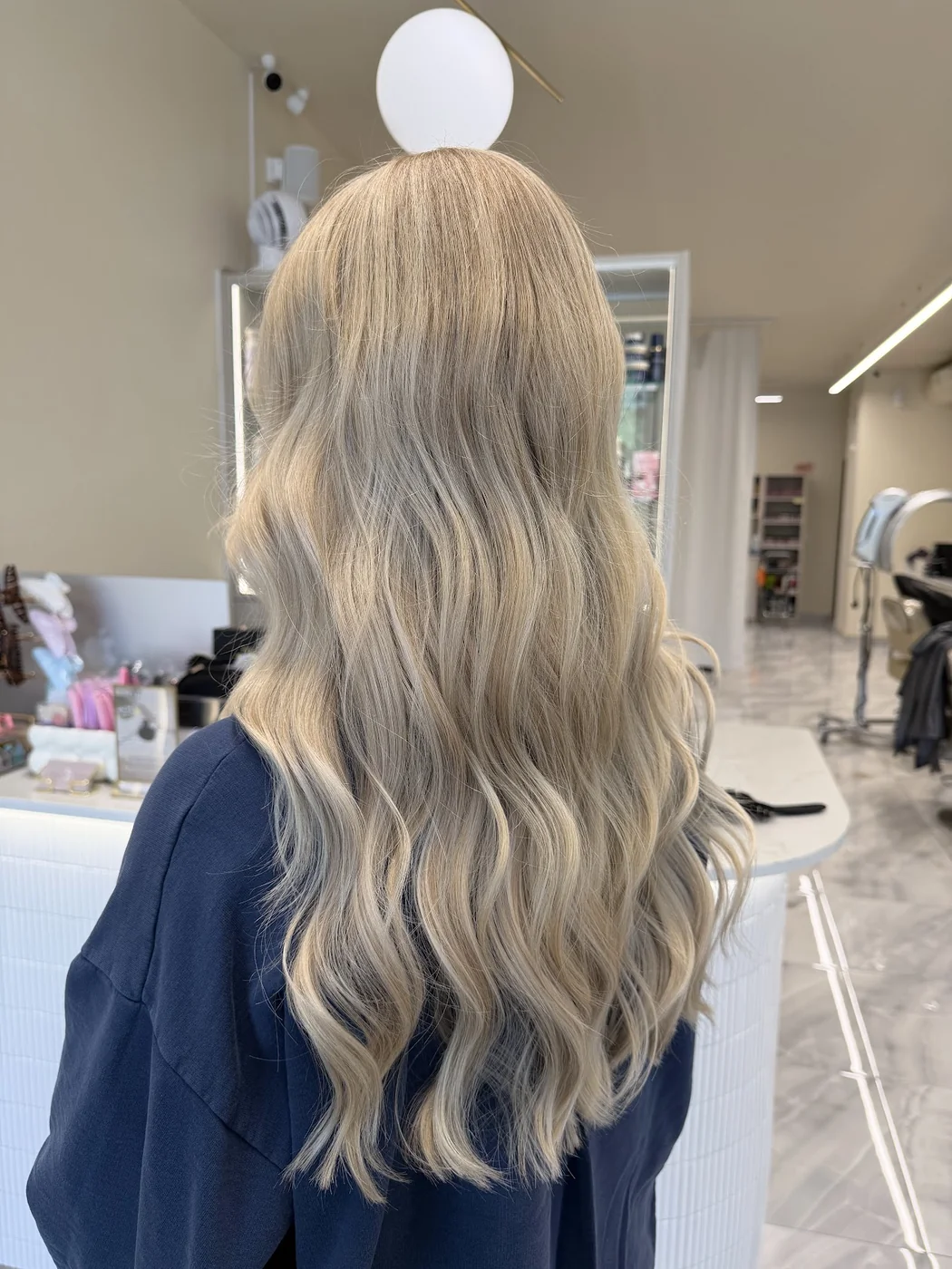 Dimensional blonde colour with layered curls at Salon Dain Toronto