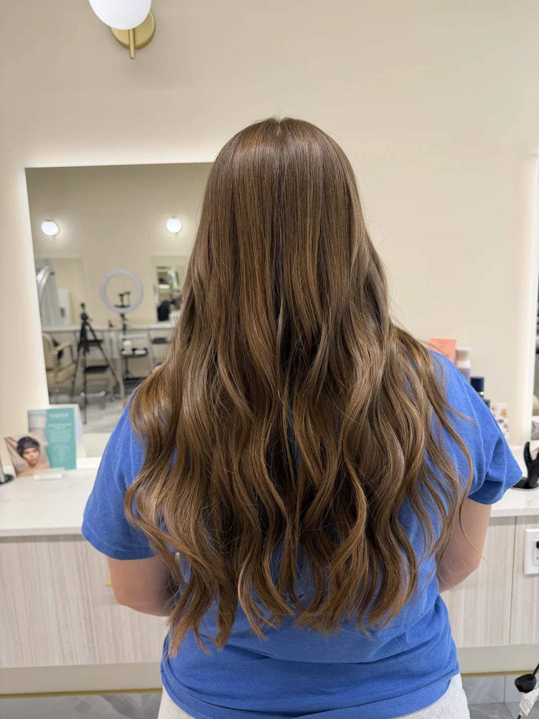 Long layered brunette haircut with soft waves at Salon Dain Forest Hill