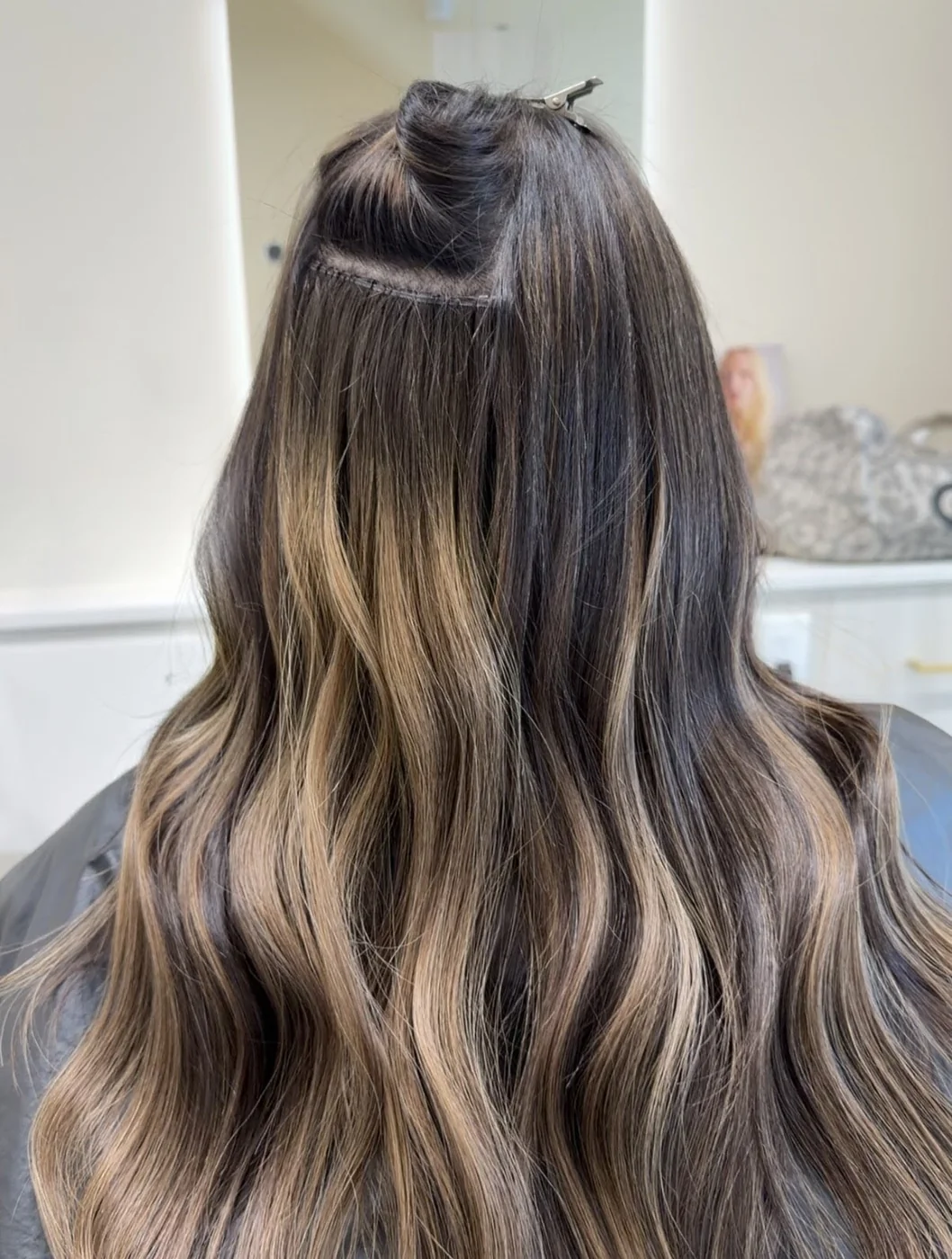 Invisible weft hair extensions being installed at Salon Dain, Toronto